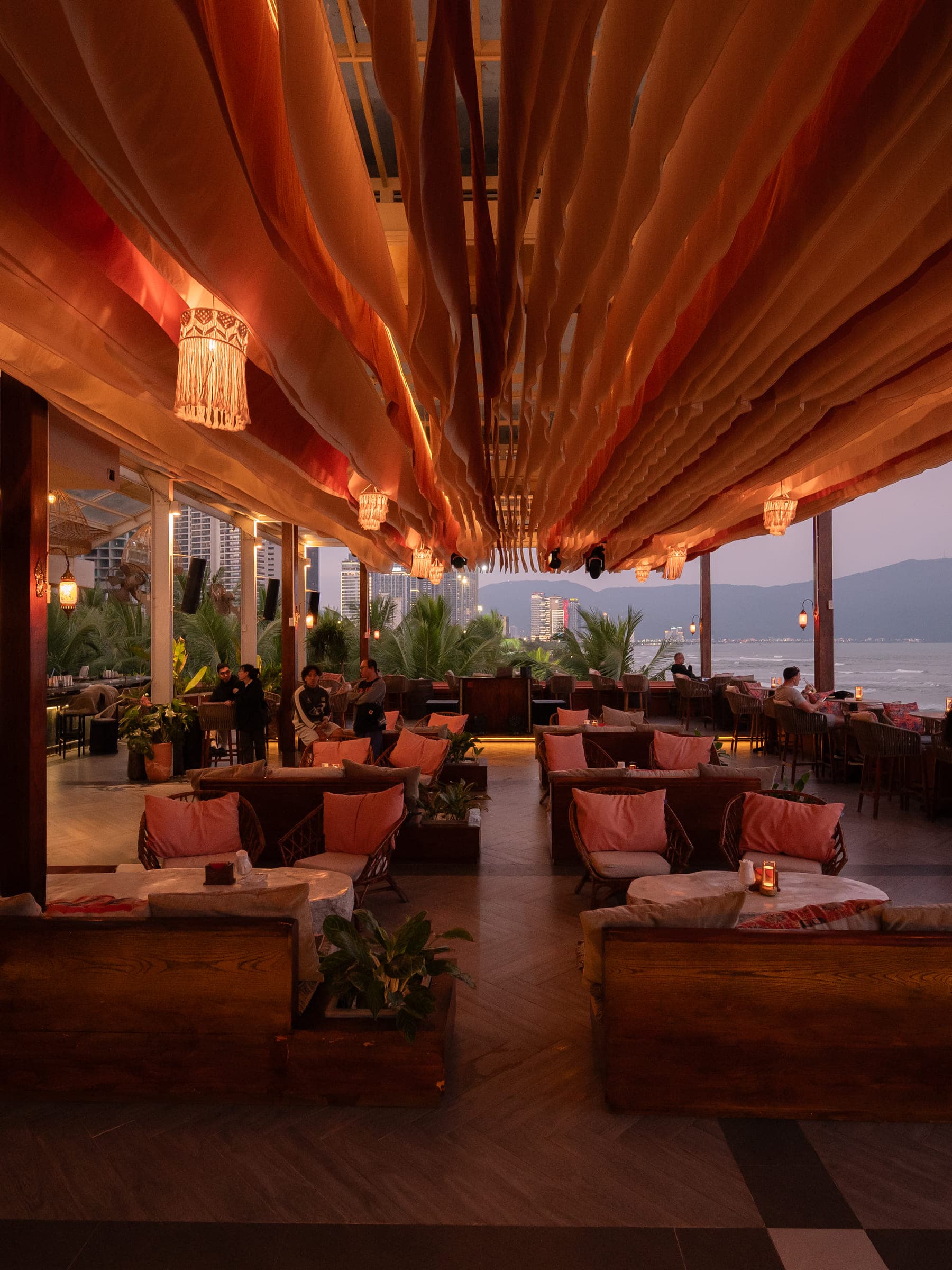 Rooftop lounge atmosphere at The Roof, Da Nang — overlooking My Khe Beach